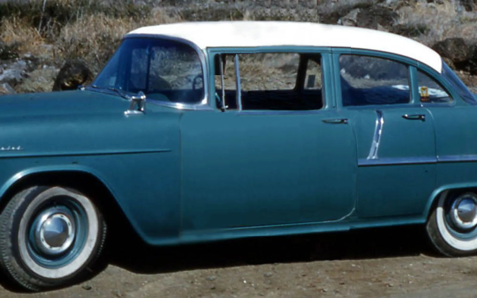 A 1955 Chevrolet 210 four-door sedan in metallic gray