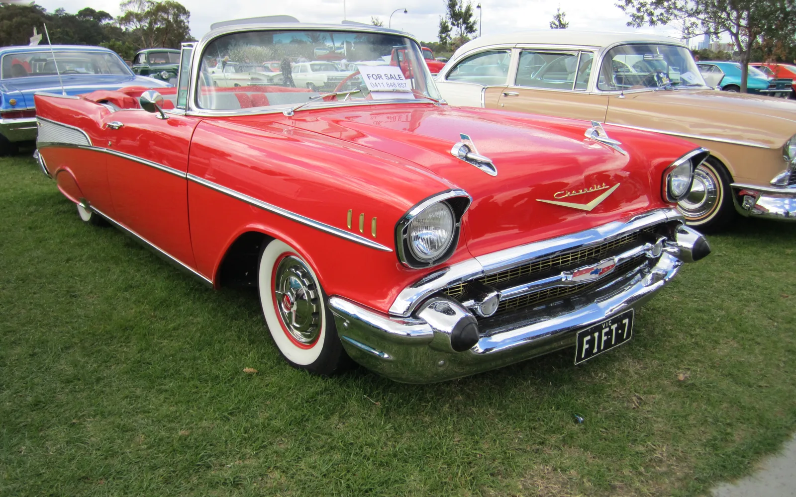 A 1957 Chevrolet Bel Air convertible in bright yellow and white